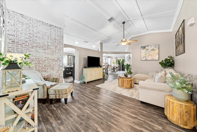 living room with dark wood-type flooring, ceiling fan, brick wall, and vaulted ceiling