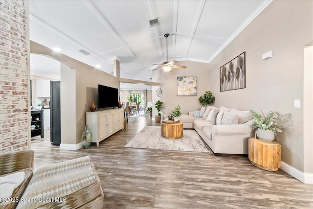 living room featuring vaulted ceiling, ceiling fan, and hardwood / wood-style floors