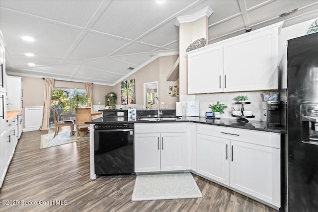 kitchen with lofted ceiling, sink, dark wood-type flooring, white cabinetry, and black appliances