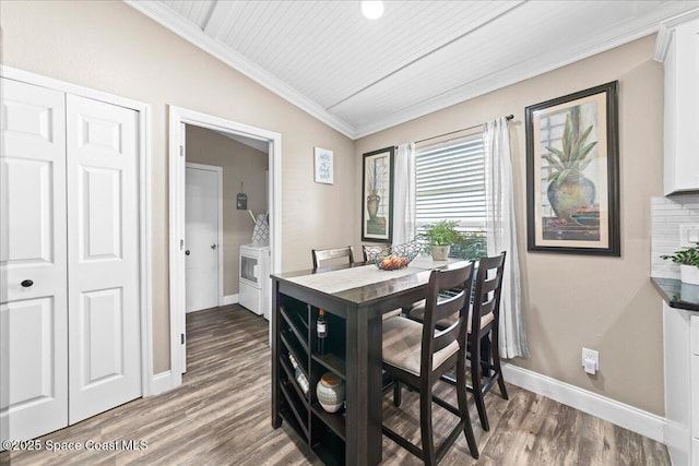 dining space with hardwood / wood-style flooring, vaulted ceiling, and crown molding