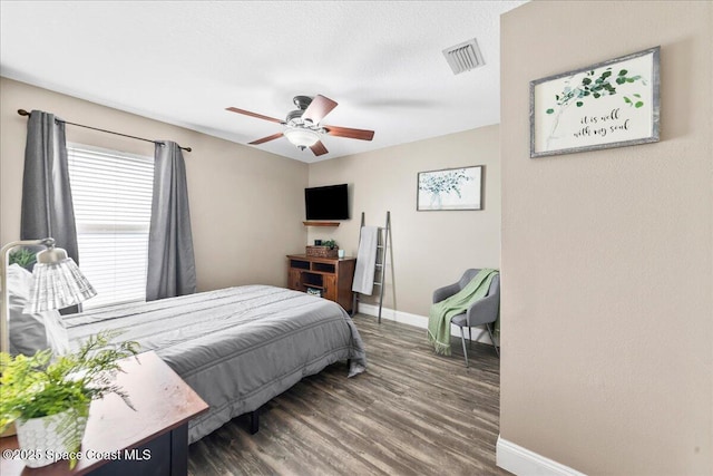 bedroom featuring ceiling fan and dark hardwood / wood-style flooring