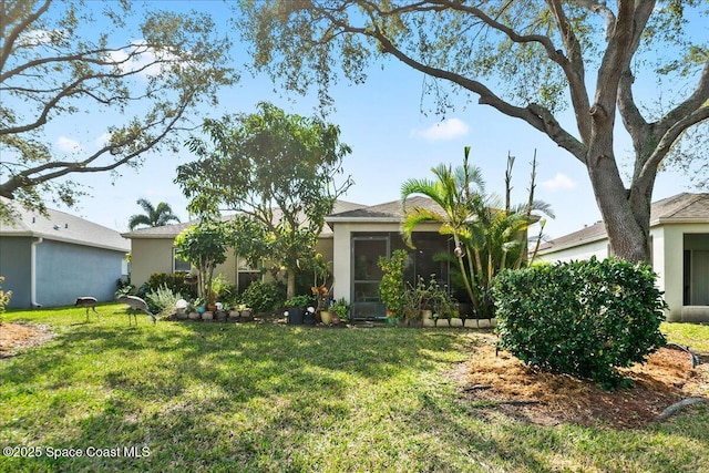 view of front of property featuring a sunroom and a front yard