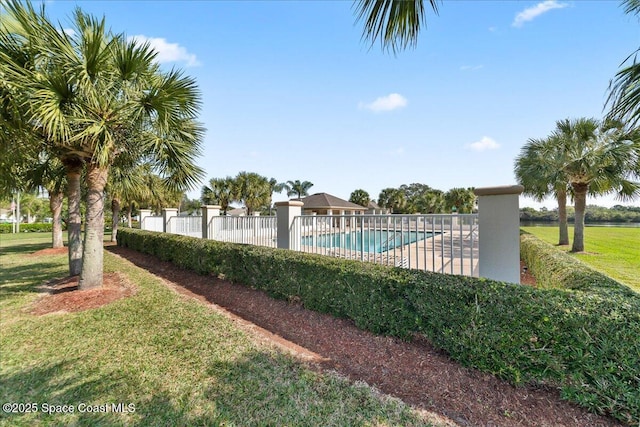 view of swimming pool with a lawn and a patio