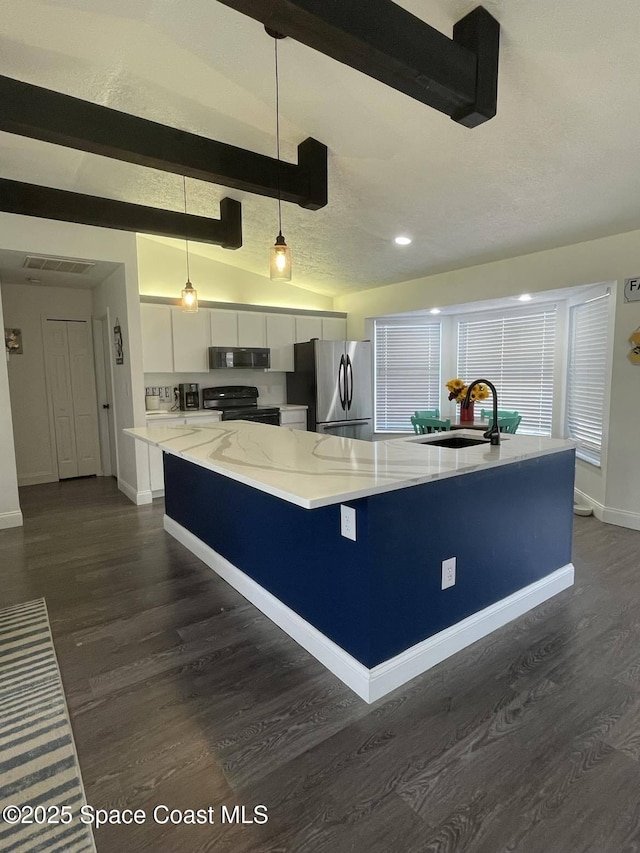 kitchen featuring sink, hanging light fixtures, black appliances, white cabinets, and a center island with sink