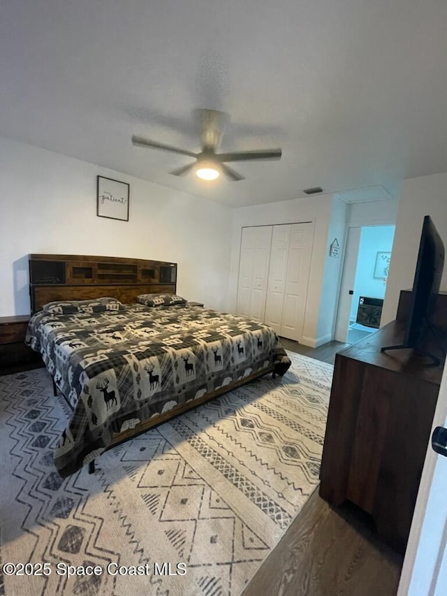 bedroom with a closet, ceiling fan, and light hardwood / wood-style flooring