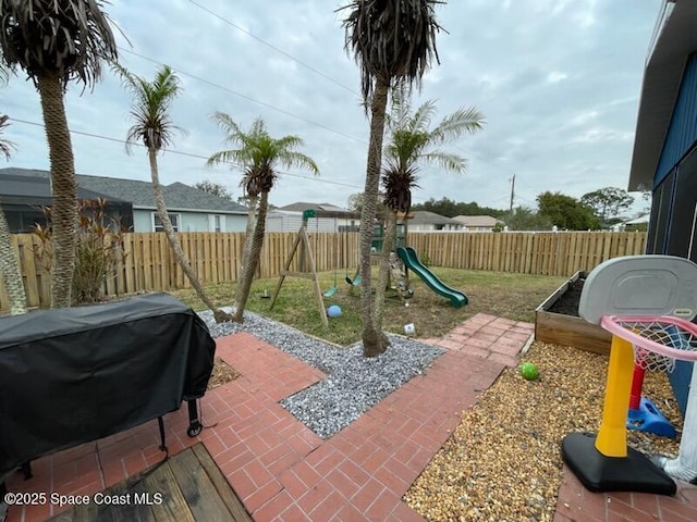 view of patio with a playground and area for grilling