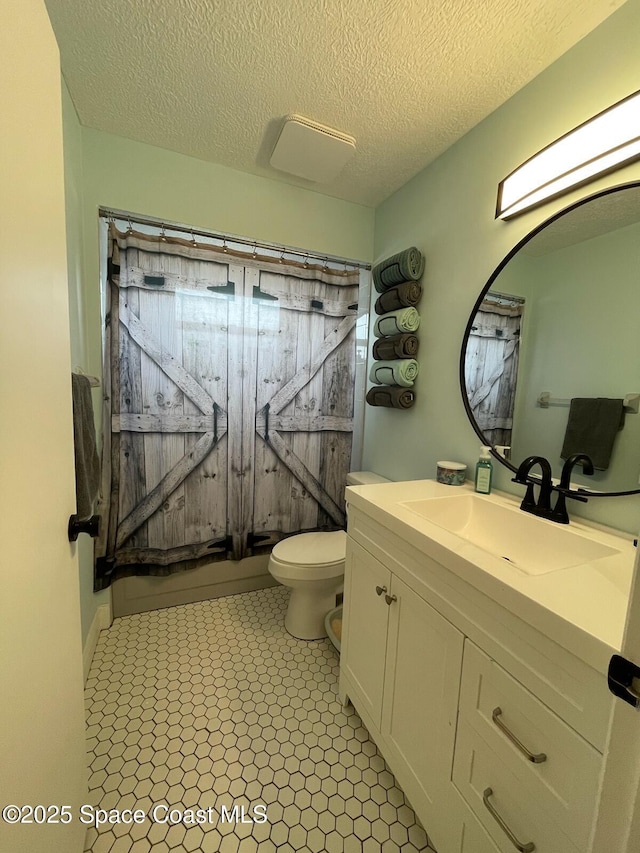 full bathroom with shower / bath combination with curtain, vanity, toilet, and a textured ceiling