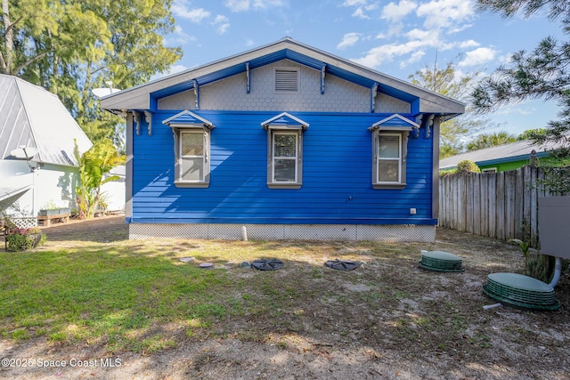 back of house with a lawn