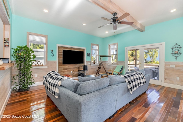 living room with beamed ceiling, dark hardwood / wood-style floors, ceiling fan, and french doors