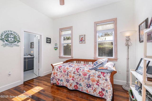 bedroom featuring connected bathroom, hardwood / wood-style floors, and ceiling fan