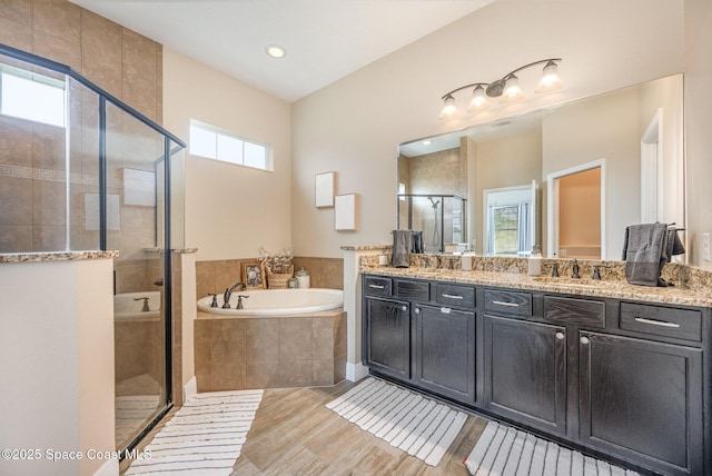 bathroom featuring vanity and separate shower and tub