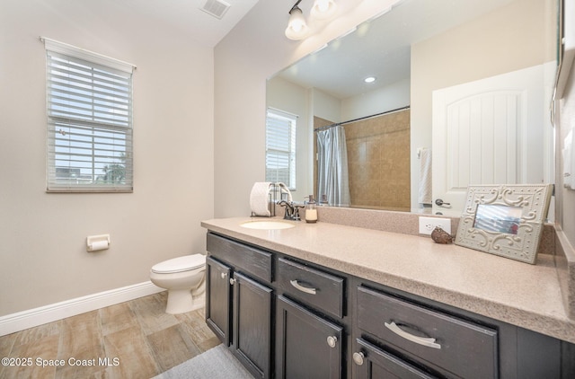 bathroom featuring vanity, hardwood / wood-style flooring, curtained shower, and toilet