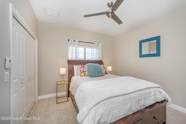 carpeted bedroom with ceiling fan and a closet