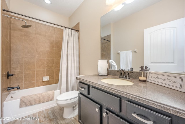 full bathroom featuring toilet, vanity, shower / bathtub combination with curtain, and hardwood / wood-style flooring