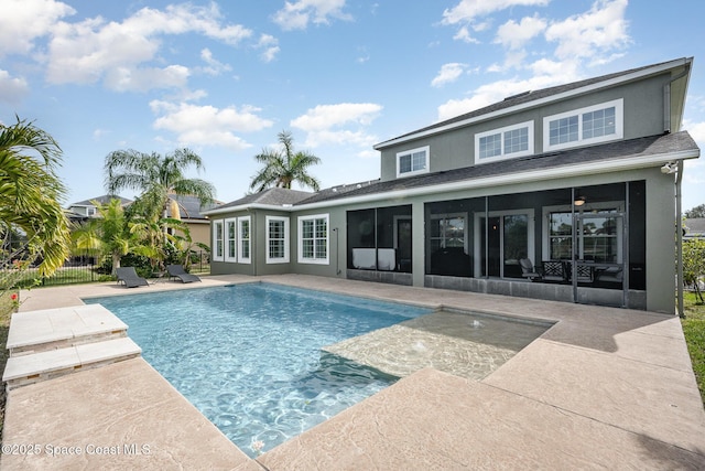 view of swimming pool with a sunroom, ceiling fan, and a patio area