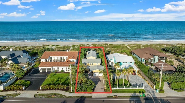 drone / aerial view featuring a water view and a view of the beach