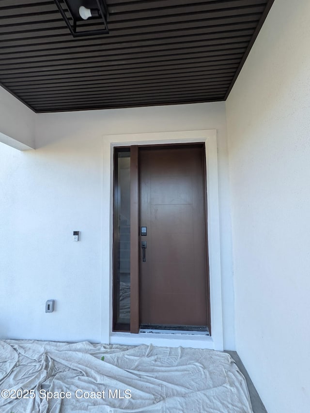 2050 S Atlantic Ave, Cocoa Beach, FL 32931 - doorway to property featuring stucco siding