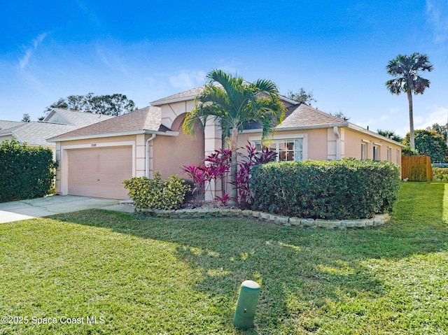 view of front of property featuring a garage and a front lawn