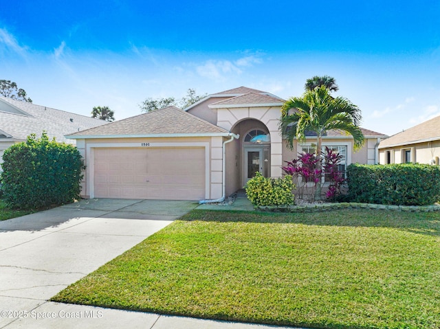 view of front of house featuring a garage and a front yard