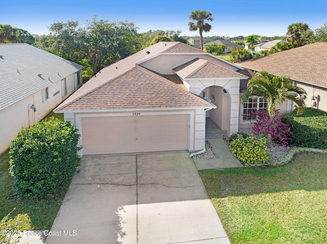 view of front of property featuring a garage and a front lawn