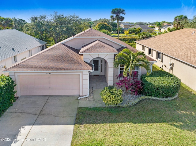 view of front facade featuring a garage and a front lawn