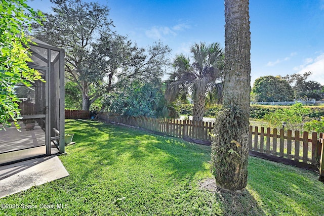 view of yard with glass enclosure