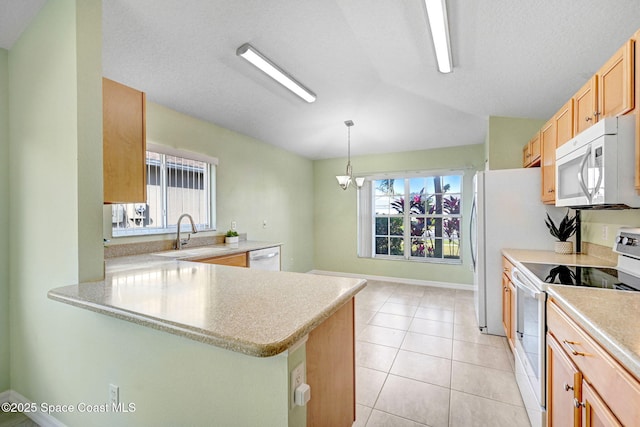 kitchen with sink, white appliances, hanging light fixtures, light tile patterned flooring, and kitchen peninsula