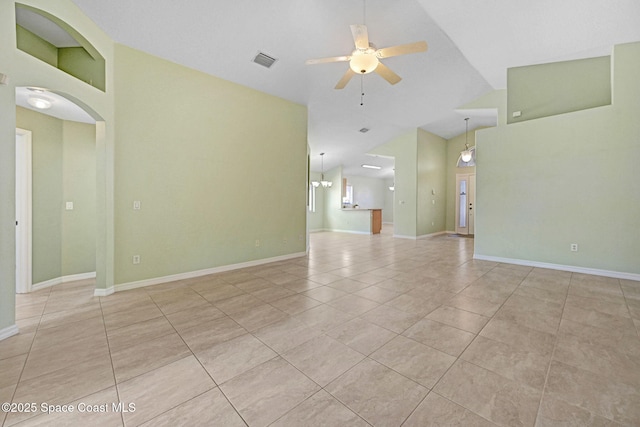 spare room featuring vaulted ceiling, ceiling fan, and light tile patterned flooring