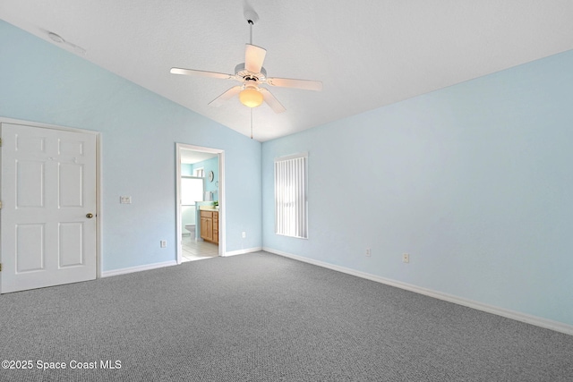 carpeted empty room featuring lofted ceiling and ceiling fan