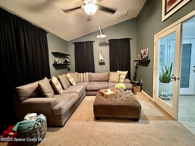 living room featuring vaulted ceiling, carpet flooring, ceiling fan, and french doors