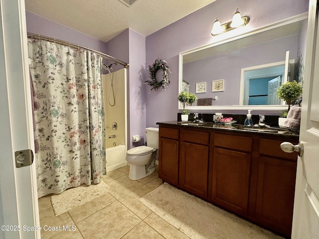 full bathroom featuring tile patterned floors, toilet, a textured ceiling, vanity, and shower / bath combo with shower curtain