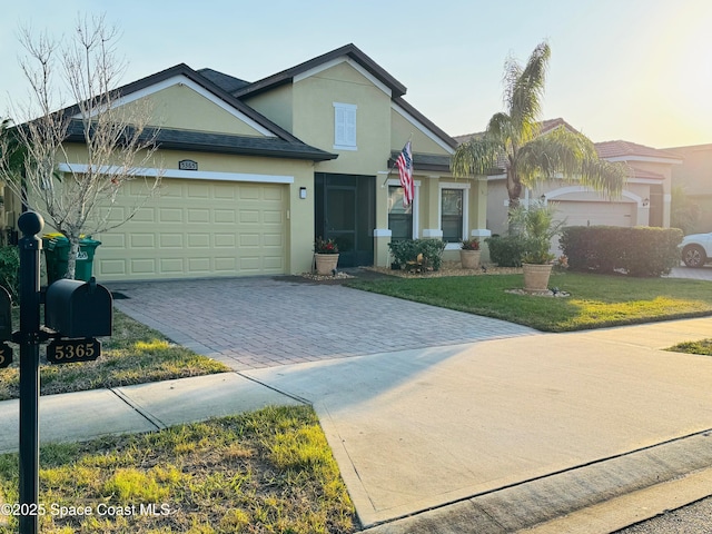 view of front of home featuring a garage and a front lawn