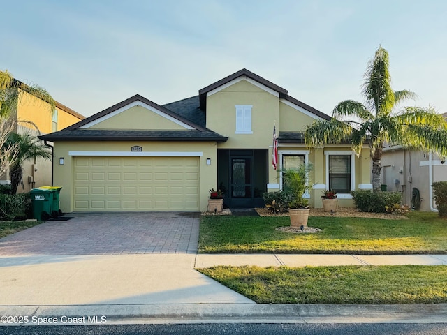 view of front of home featuring a garage and a front yard