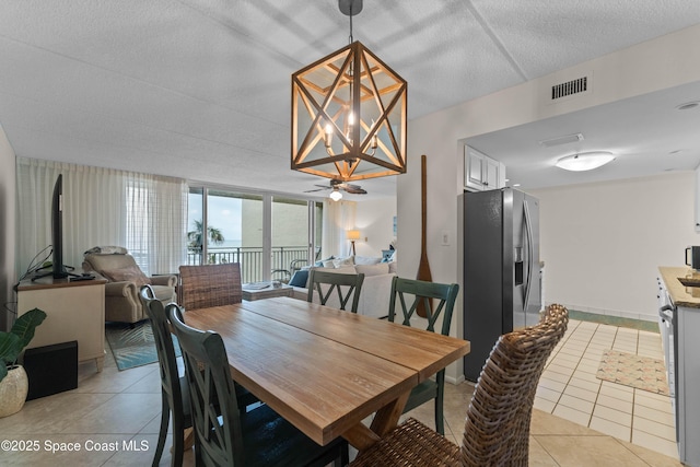 dining room with expansive windows and light tile patterned floors