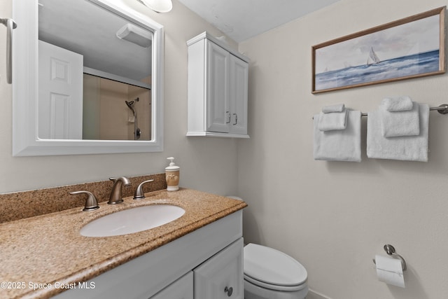 bathroom featuring walk in shower, vanity, and toilet