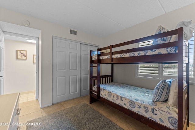 bedroom featuring light tile patterned flooring and a closet