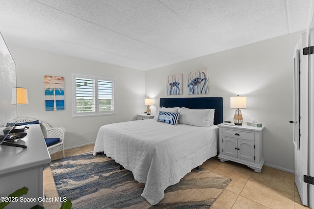 bedroom featuring light tile patterned flooring and a textured ceiling