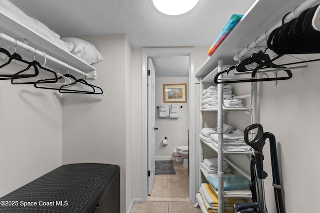 spacious closet featuring light tile patterned flooring