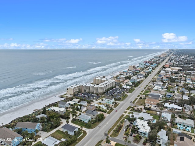 aerial view with a water view and a beach view