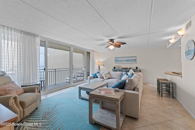 tiled living room featuring ceiling fan