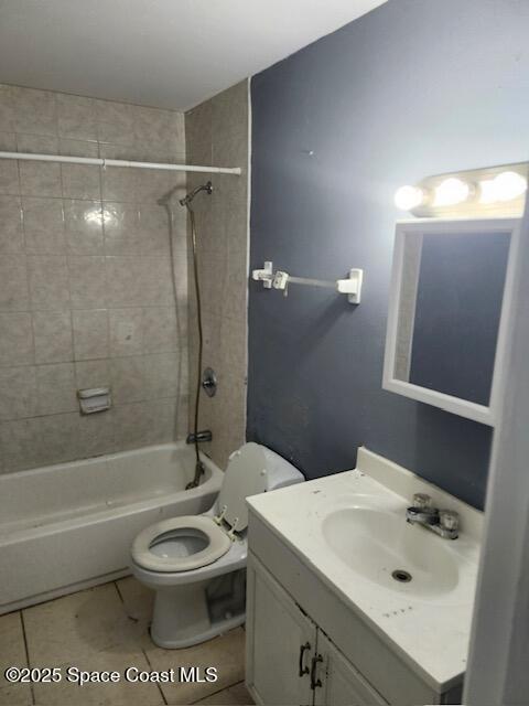 full bathroom with vanity, tile patterned floors, toilet, and tiled shower / bath