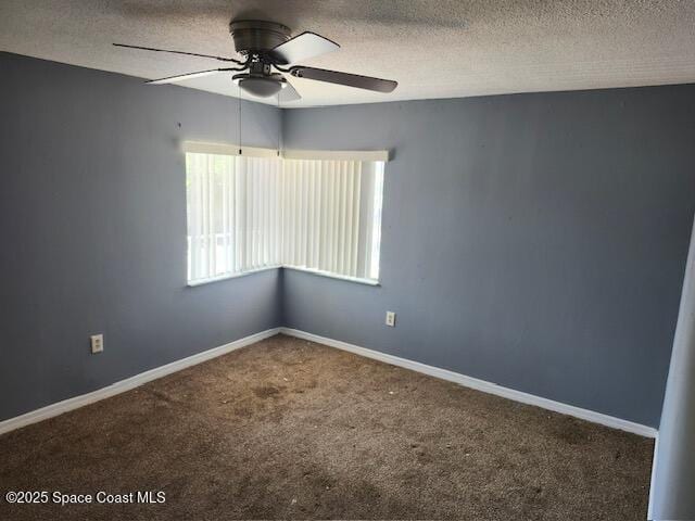 carpeted empty room with ceiling fan and a textured ceiling