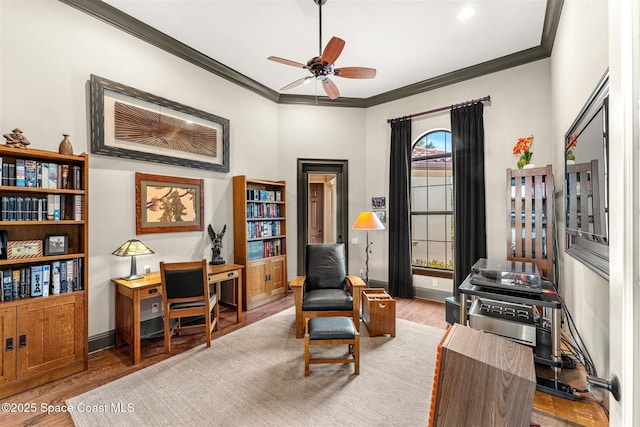 home office with crown molding, light hardwood / wood-style floors, and ceiling fan