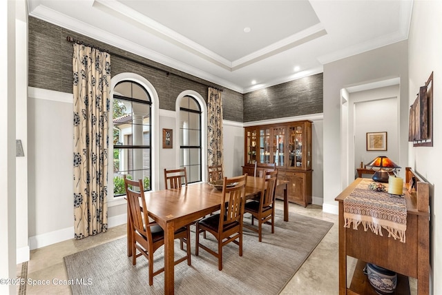 dining room with crown molding and a raised ceiling