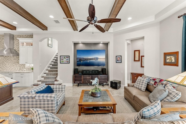 living room with beamed ceiling and ceiling fan