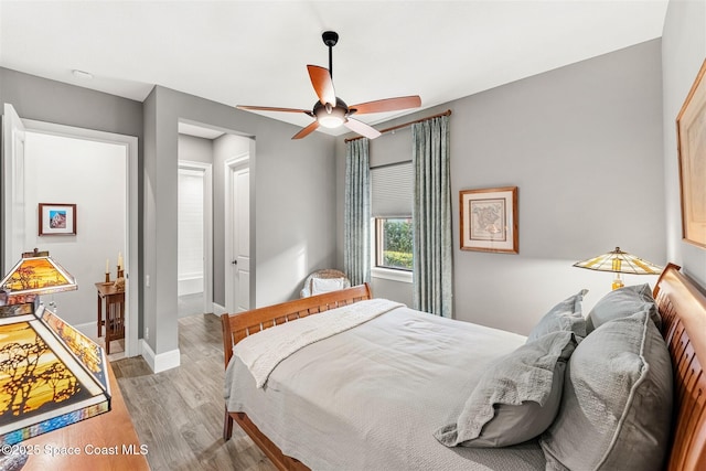 bedroom with ceiling fan and light hardwood / wood-style flooring