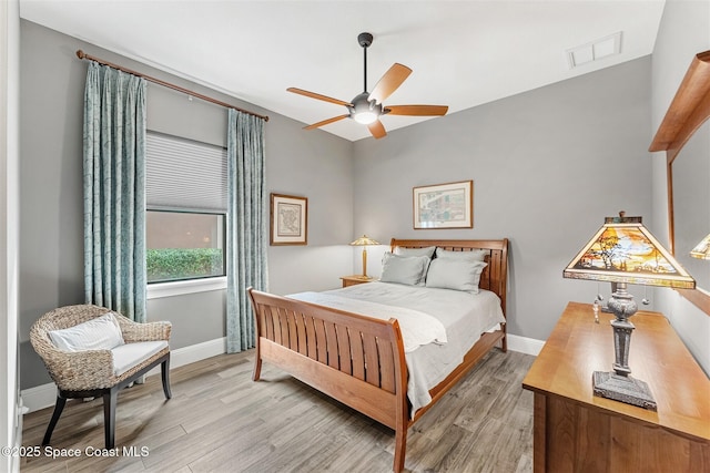 bedroom with ceiling fan and light wood-type flooring