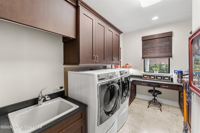 laundry room featuring cabinets, sink, and washing machine and clothes dryer