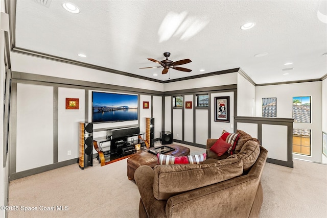 carpeted living room with crown molding, ceiling fan, and a textured ceiling