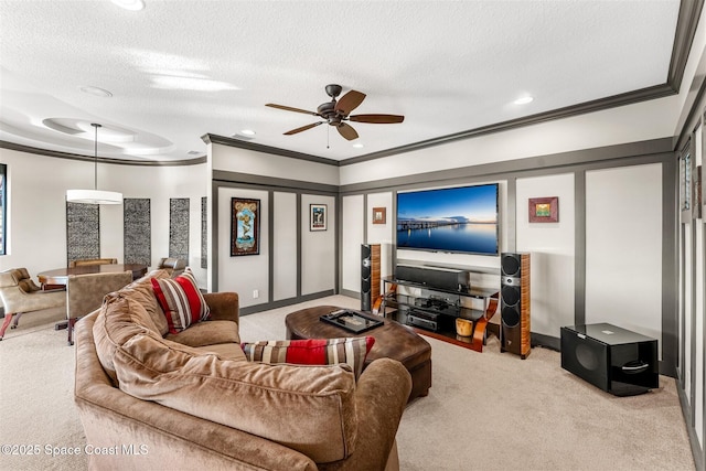 living room with crown molding, light colored carpet, ceiling fan, and a textured ceiling